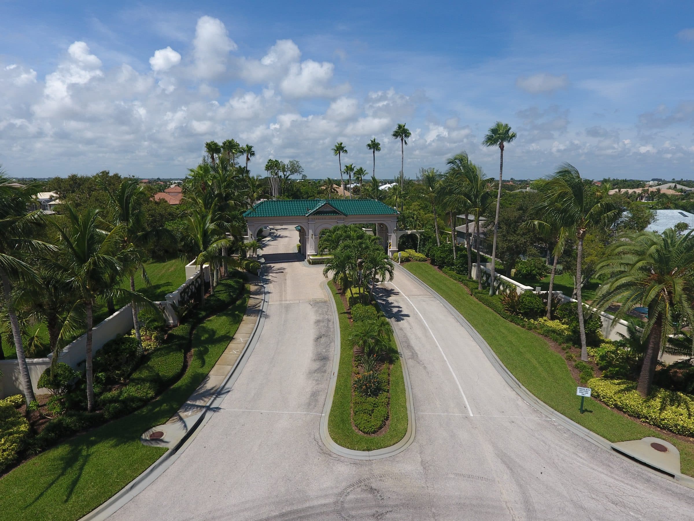 Gated community entrance with palm trees