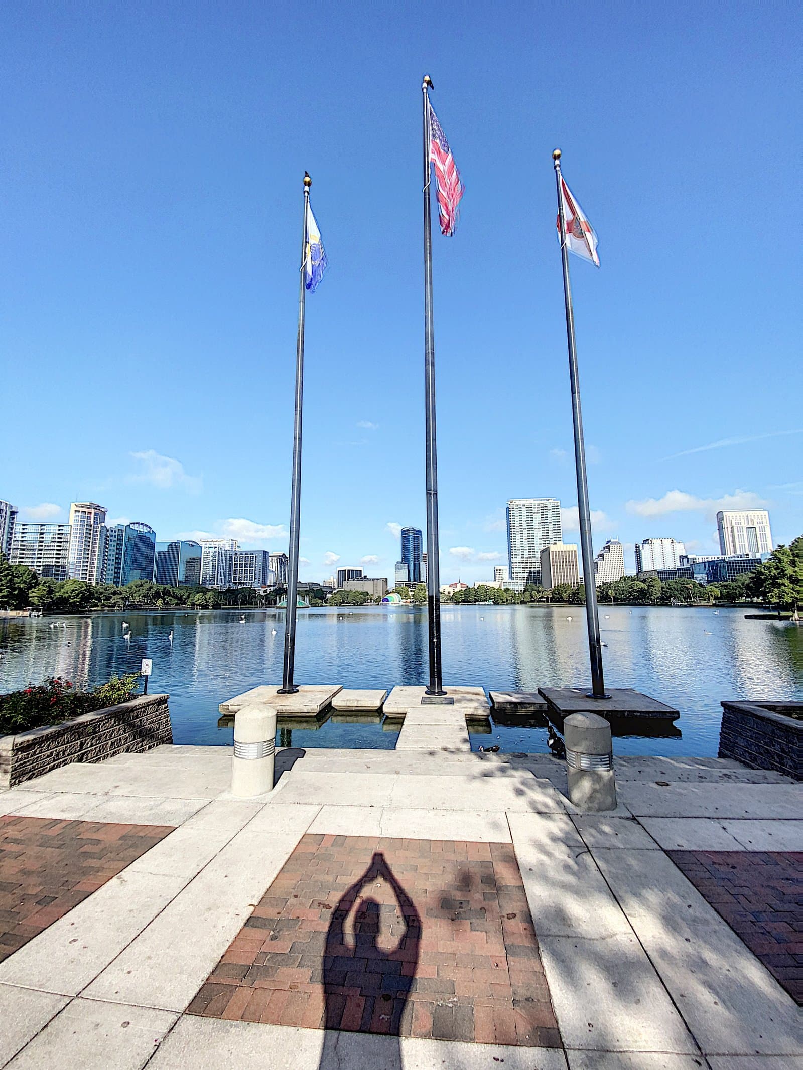 Lake Eola flagpole plaza with the downtown skyline beyond