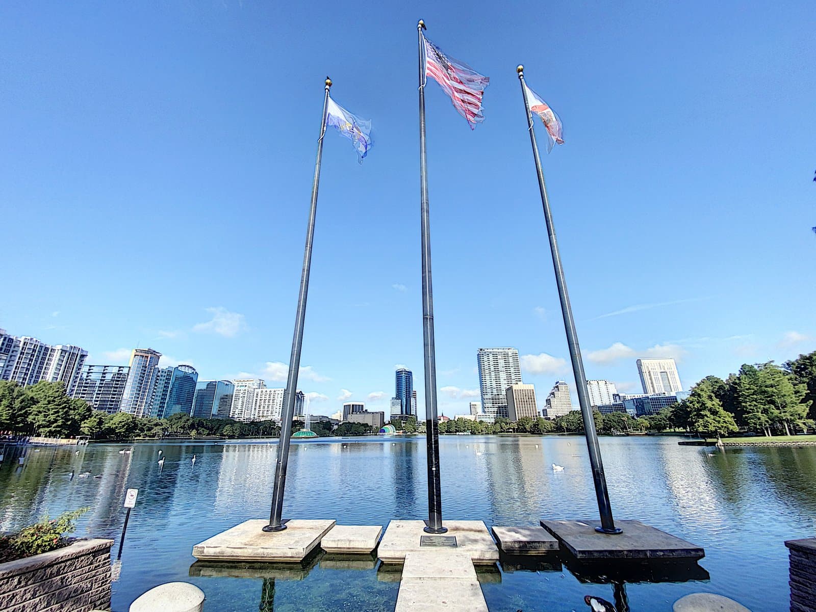 Lake Eola lakeside flagpoles with the city skyline backdrop