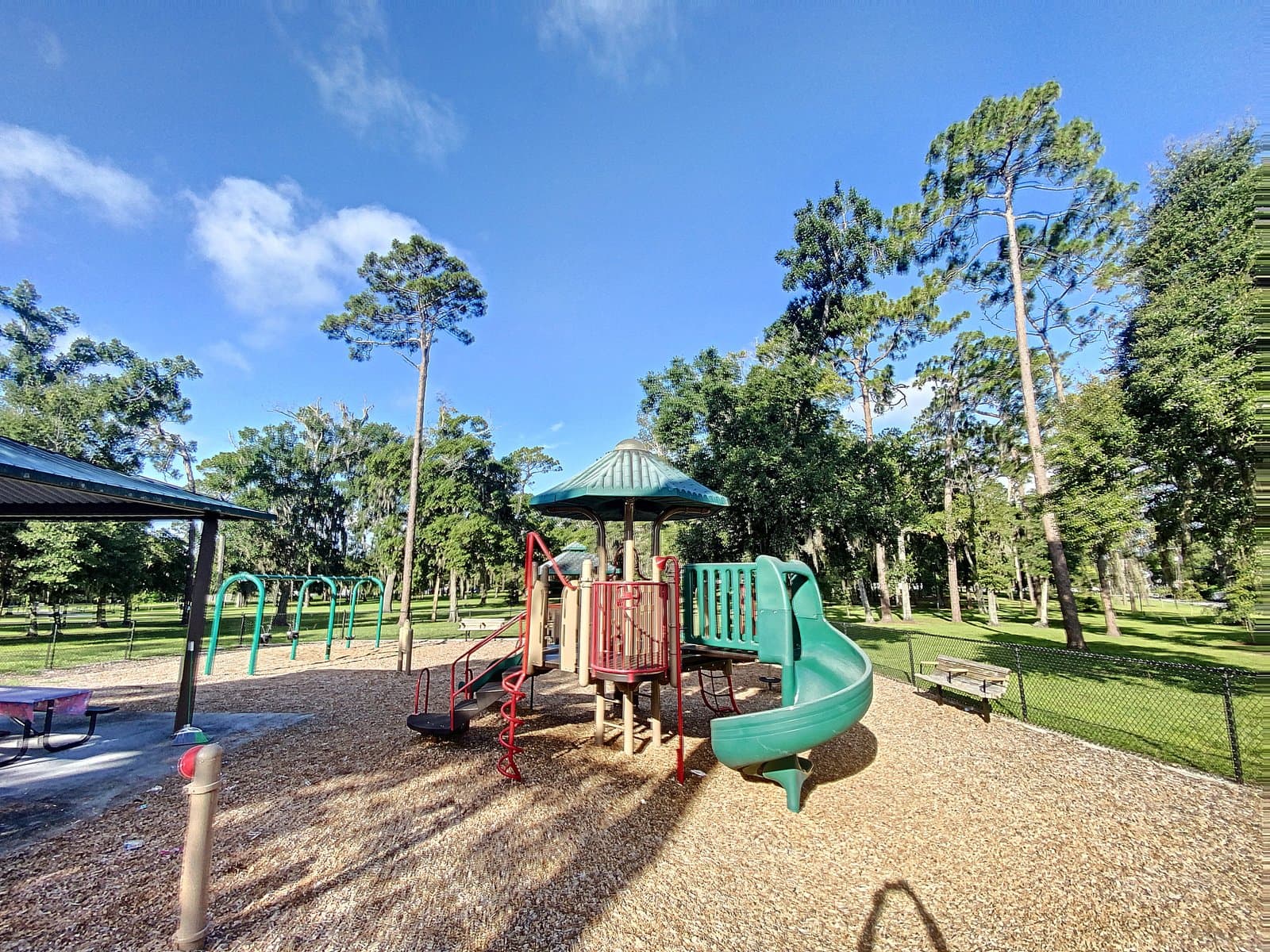 Neighborhood park playground under tall pines at Wadeview Park