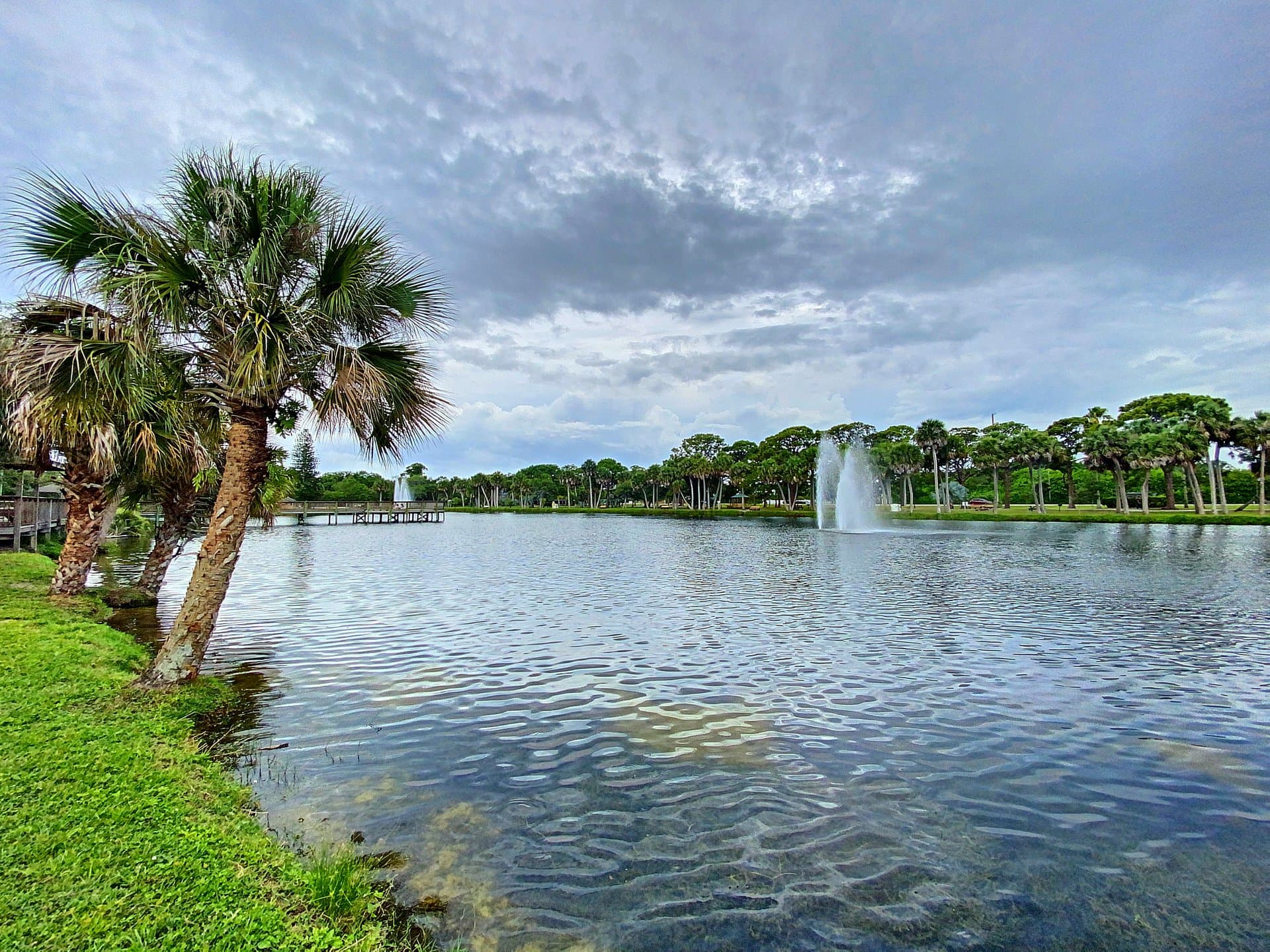 Indian Harbour Beach community lake with fountain and palm trees