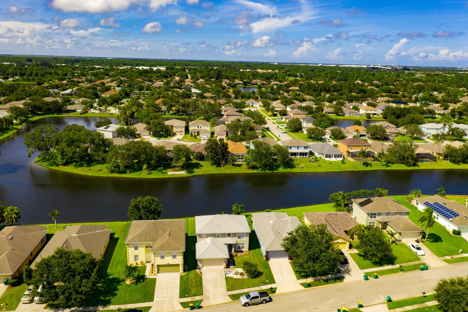 Aerial view of a Melbourne lakefront neighborhood with tree-lined streets