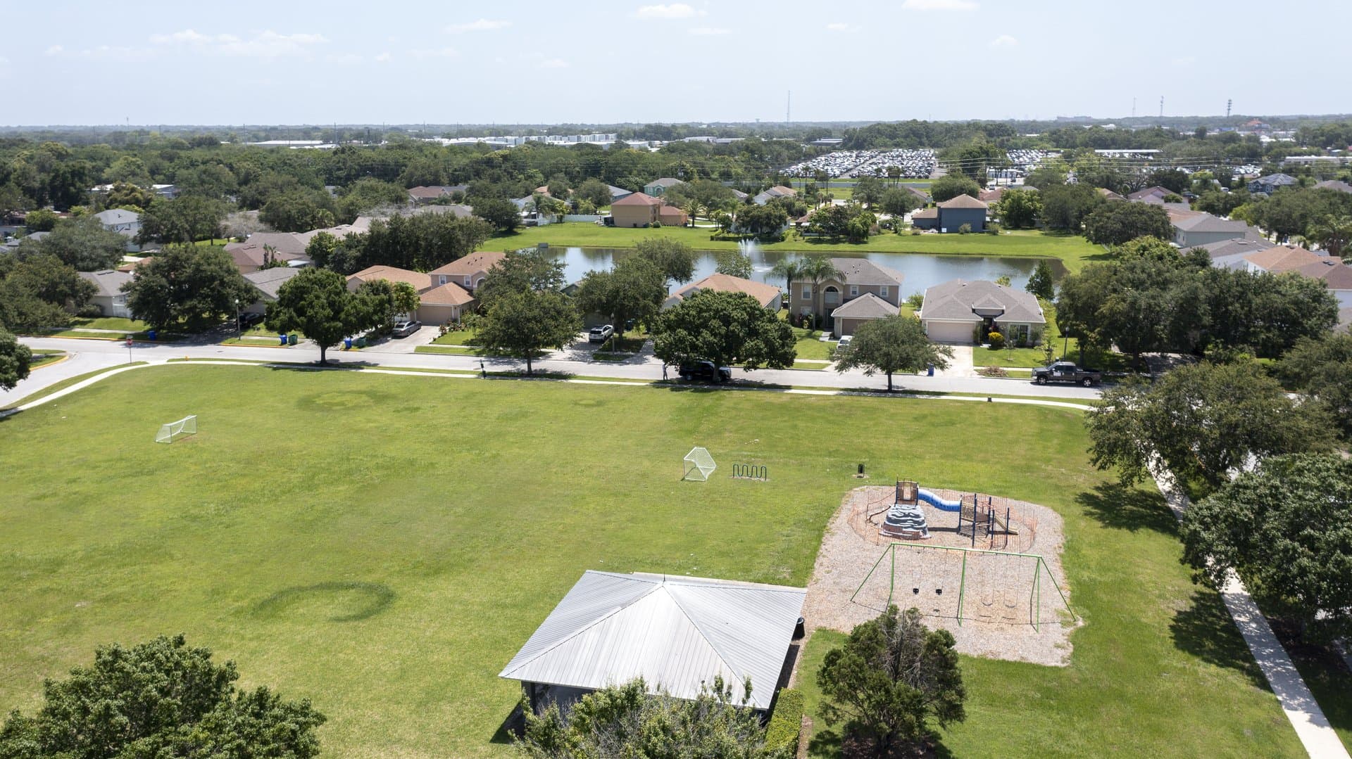 Aerial view of a Winter Garden neighborhood with community park and lake
