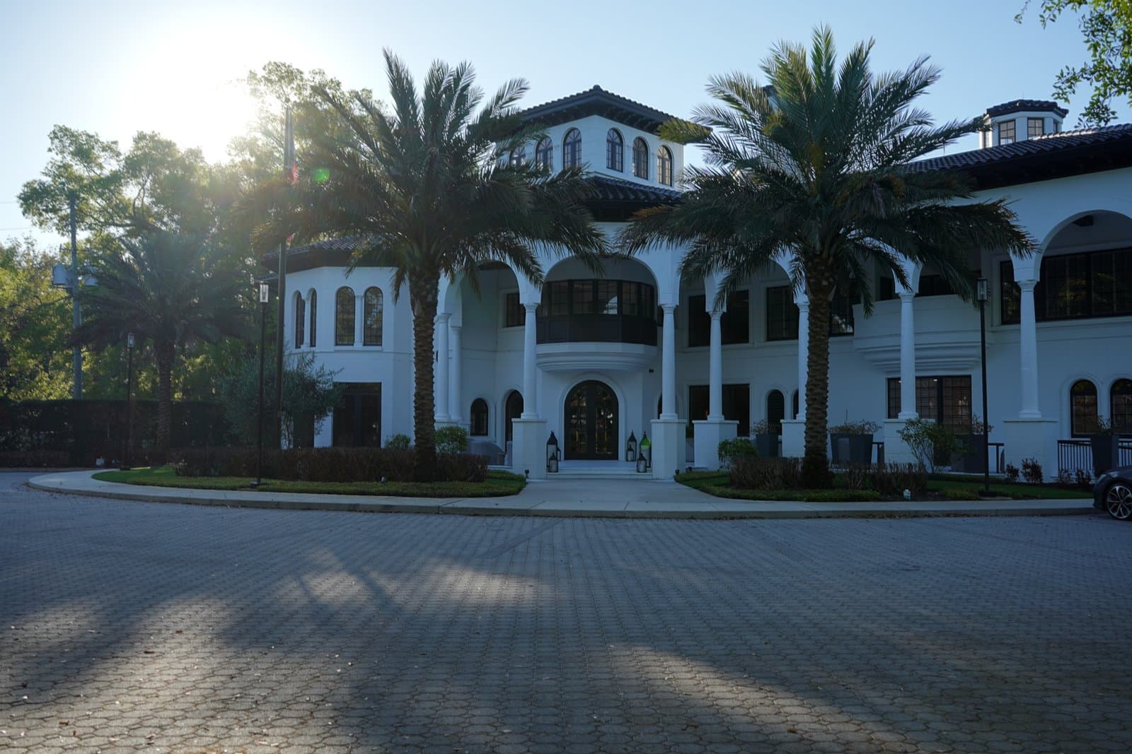 Isleworth Country Club's white Mediterranean-style clubhouse with palm-lined drive, Windermere, FL