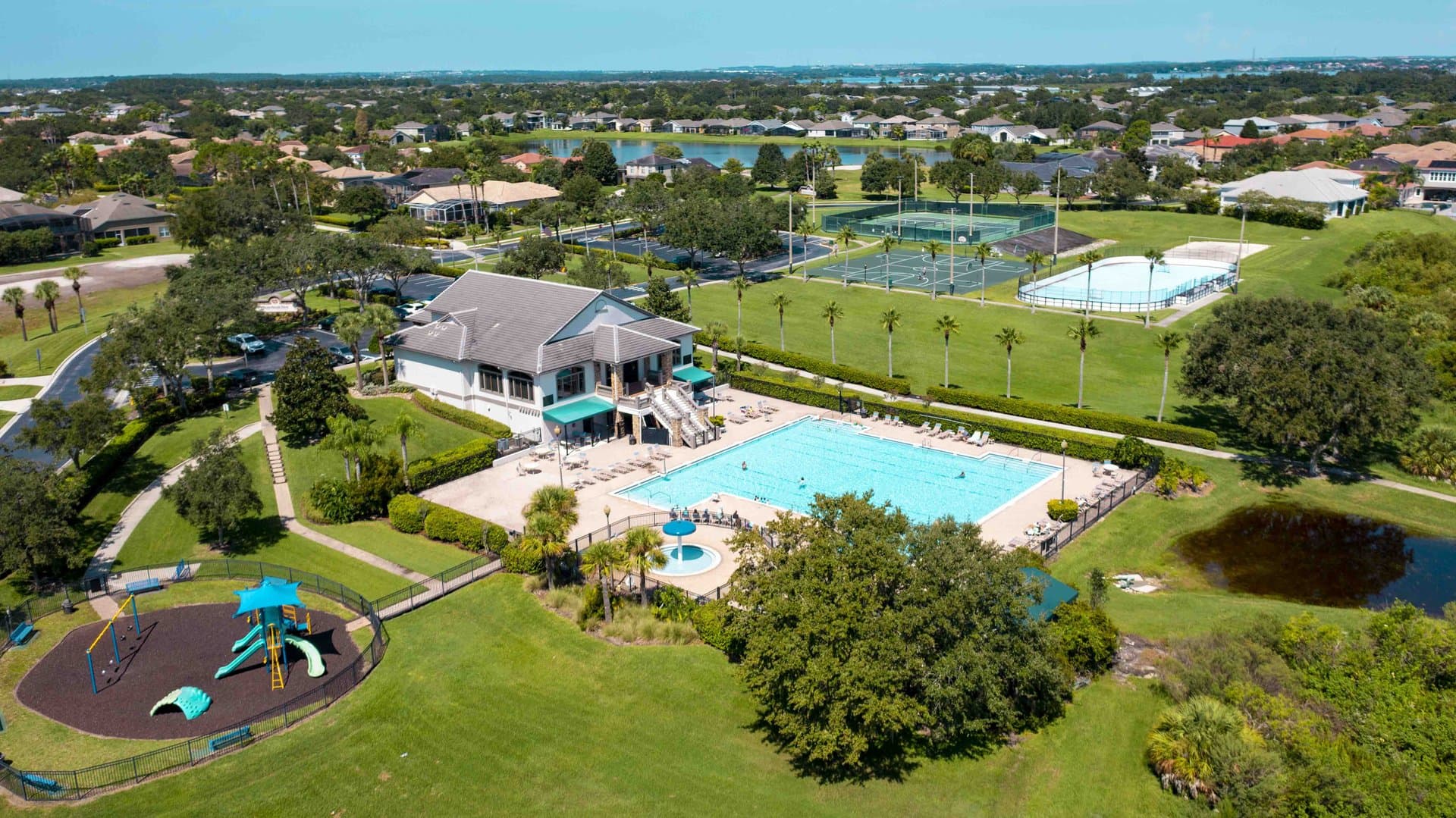 Winter Garden master-planned community — aerial view of clubhouse, resort pool, and tennis courts